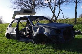 burnt car on green grass