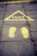 yellow road sign on the pavement