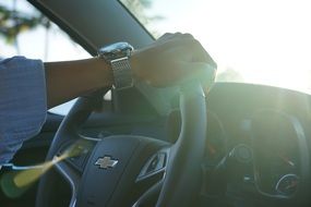 Picture of the man is driving car at the sunlight