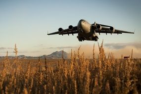 military aircraft over a field