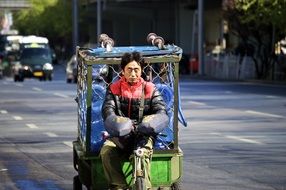 asian man riding truck on street, china, beijing