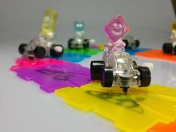 toy race cars on a color track