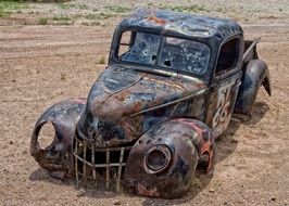 rusty pickup in the sand in arizona