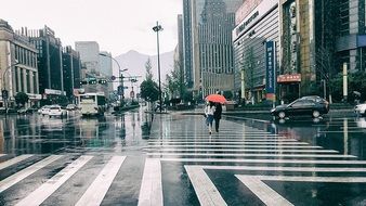 couple in chine street with red umbrella