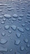 closeup picture of water drops on the blue surface
