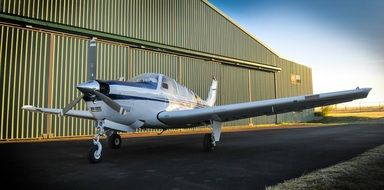 private plane with a propeller on the background of the hangar