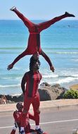 dark skin street acrobats at coast