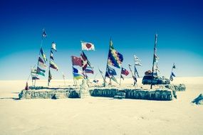 different flags in the desert of bolivia