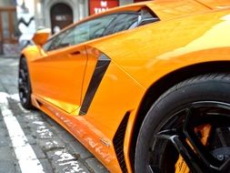 yellow lamborghini on city street close up