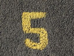 yellow number five on the asphalt