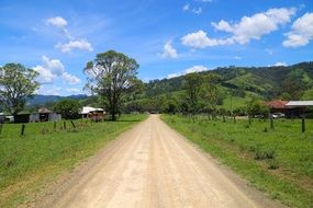 long soil road at green countryside