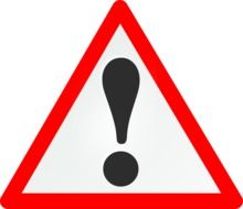 black exclamation mark on a road sign