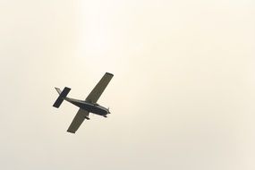 the plane is flying under the clouds