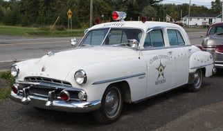 old white american car on a road