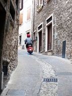 motor scooter on the narrow street, italy, limone sul garda