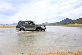 picture of the jeep car is in a river