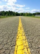 yellow dividing strip on a country road close up