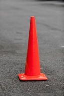 red road cone on the asphalt close-up