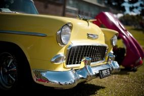 yellow front of the car with an ornament
