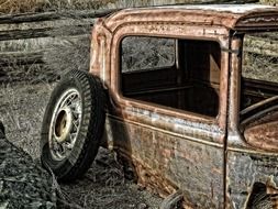 rusty car body and wheel around it