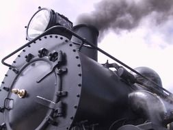 locomotive lets out black steam