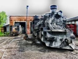 gray locomotive on the railway yard