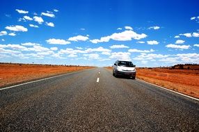 car on a desert road in australia