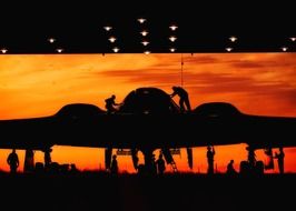 black silhouette of a airplane at orange sunset