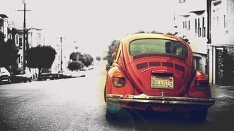 red old car on black and white street, monochrome