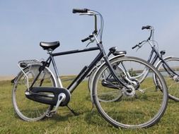 two bicycles on green meadow