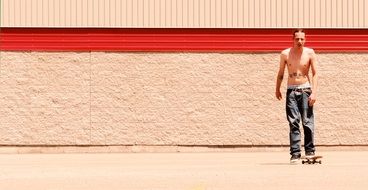 man riding a skateboard near the wall