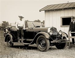 cool man on antique lincoln car