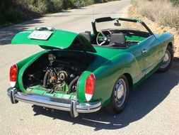 green vintage volkswagen car with open motor