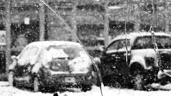 monochrome picture of car parking in wet weather