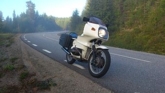 new white motorcycle on road in mist