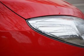 headlight on a red car close up
