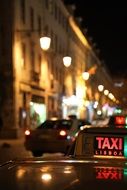 taxi in downtown at night, portugal, lisbon