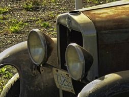 front of a rusty old car