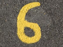yellow number six on the road