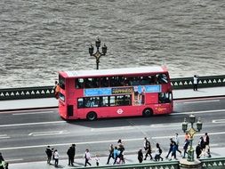 red touristic bus in london street scene