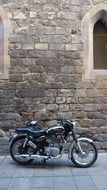 motorcycle at the stone wall