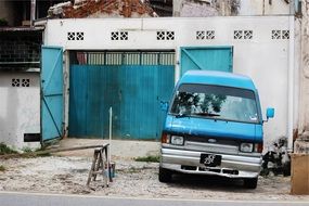 blue car near the garage