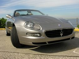 silver maserati in the parking lot on the promenade