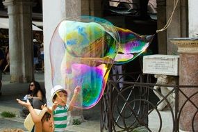 children playing with soap bubbles on the street