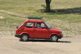 old red fiat on dirt road