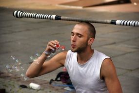 clown juggler blowing bubbles