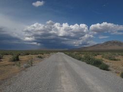 traveling along a rural road under the clouds