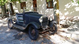 retired retro car on street at house