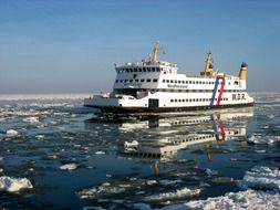 white ferry among the ice of the ocean