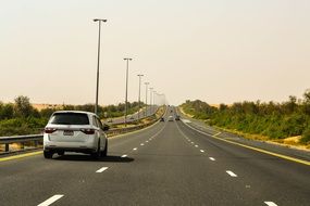 white car on the road in Dubai